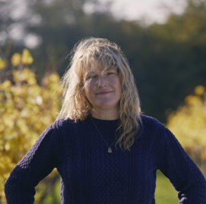 Emma Lundie, head of operations at Forty Hall Vineyard, pictured with the vineyard in the background.