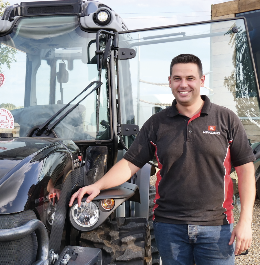 Kirkland employee Ben Devine with Antonio Carrero tractor on fruit and viticulture article