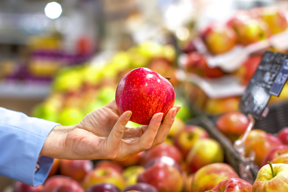 Women Hand Choosing Apple At Supermarket
