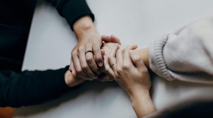 Hands being held in support for mental health 