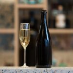 sovereign wine bottle with glass of sparkling wine on a table